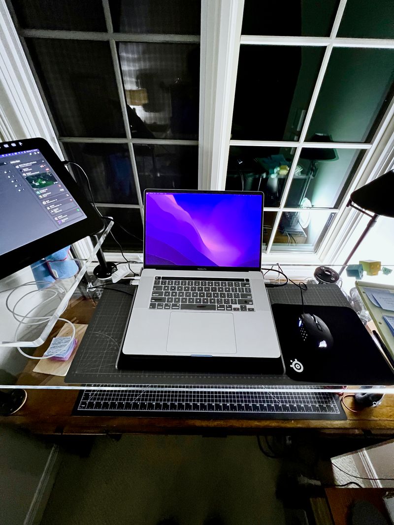 A pristine macbook on an acrylic surface.